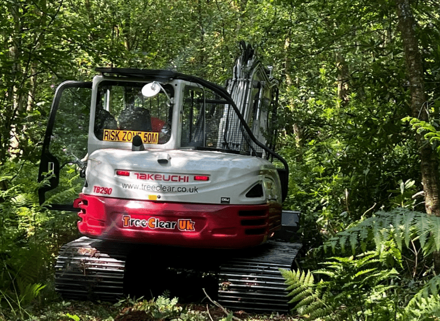 Treeclear UK vehicle tackling overgrown woodland